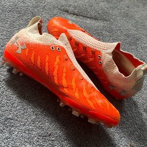Orange and white Under armour cleats